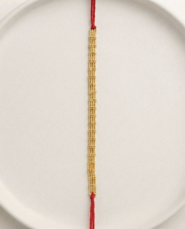 Handcrafted Rakhi with Traditional Gold Toned Woven Centerpiece